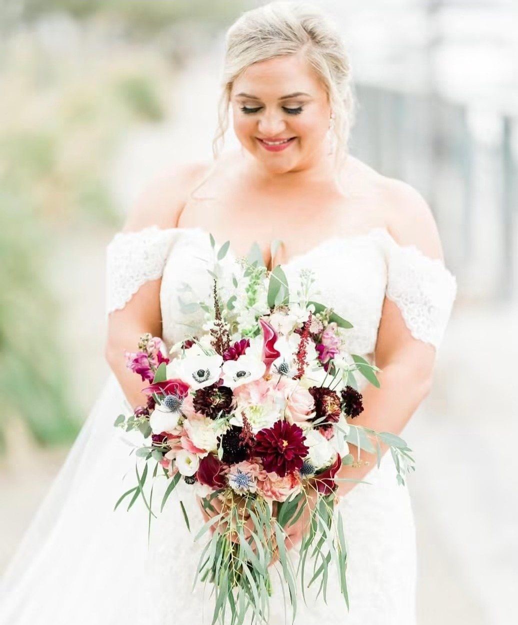 Bride holding a burgundy, blush and white bouquet