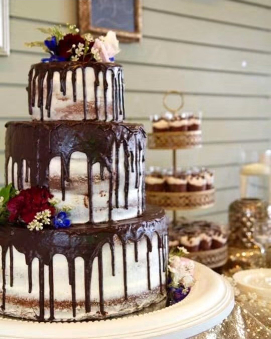 Chocolate drip wedding cake with fresh flowers