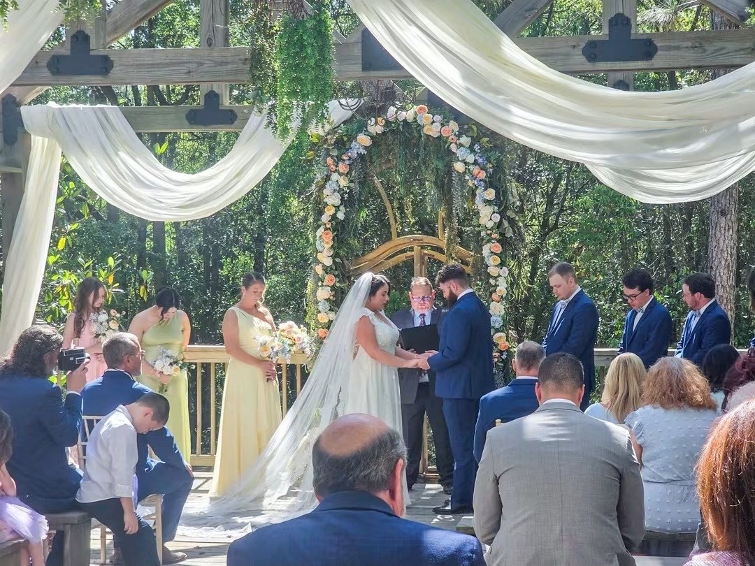 Garden ceremony under draped fabric and florals