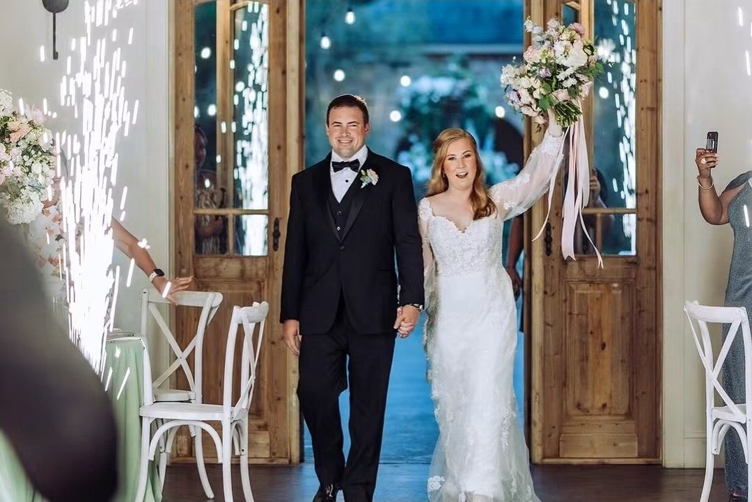 Couple making their grand exit through sparklers