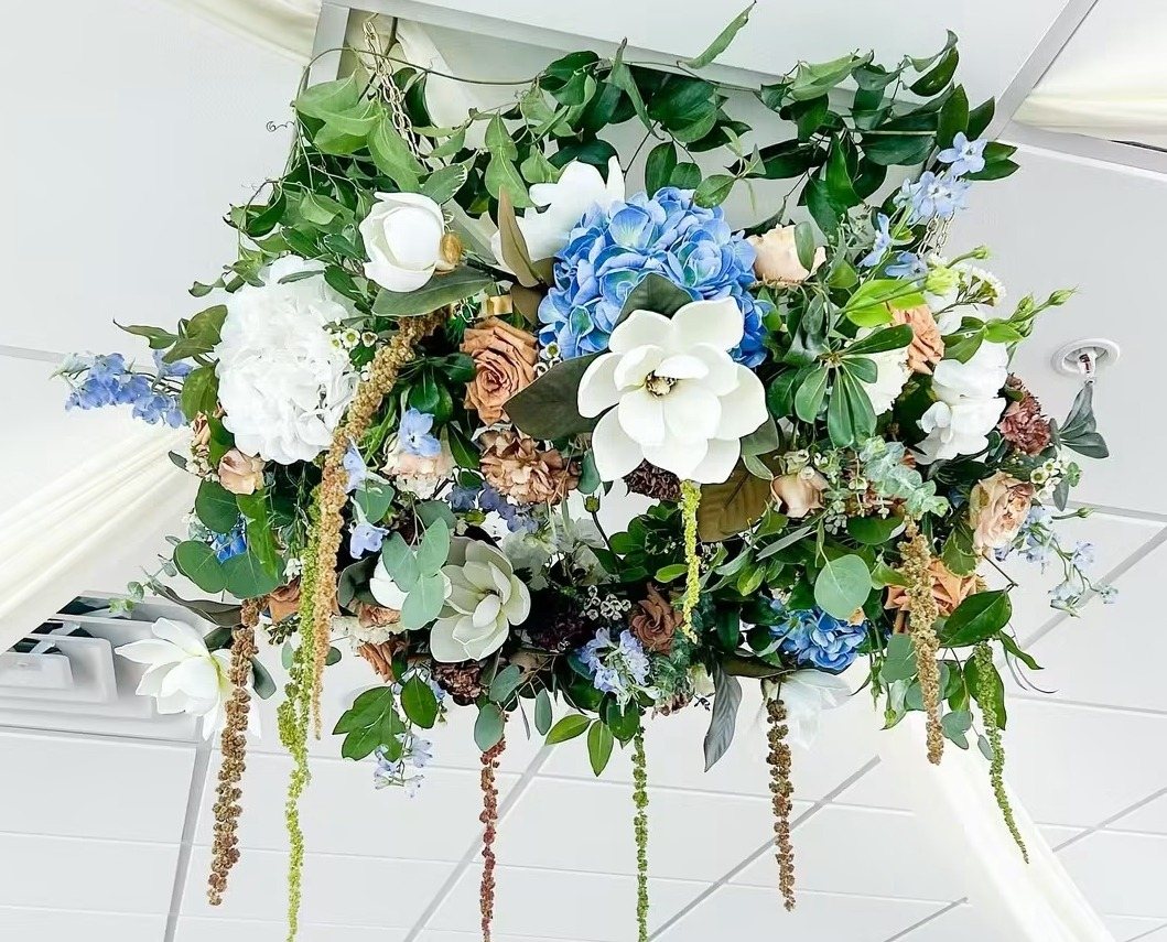 Hanging floral piece of white and blue blooms and greenery