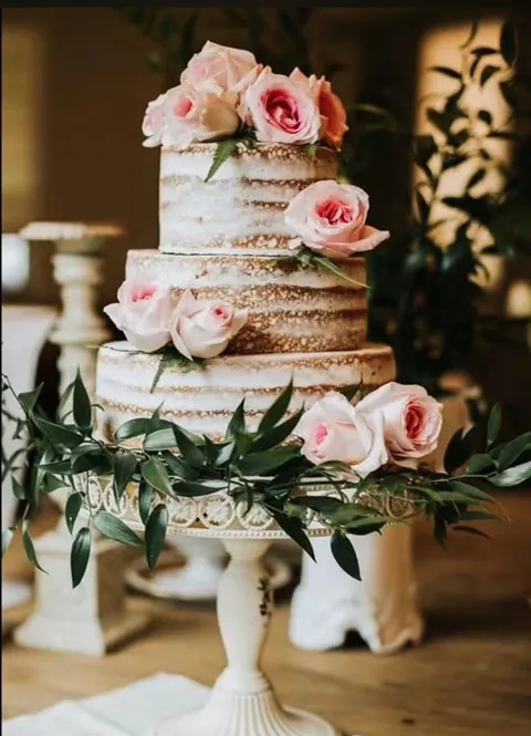 Naked wedding cake with blush roses and greenery