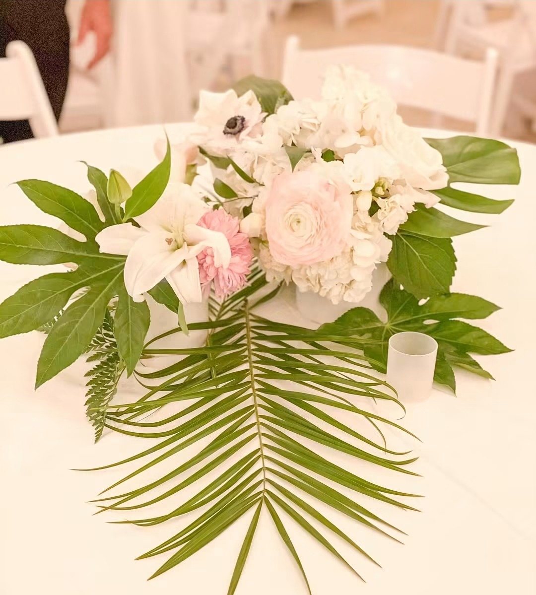 Blush roses and palm leaf centerpiece